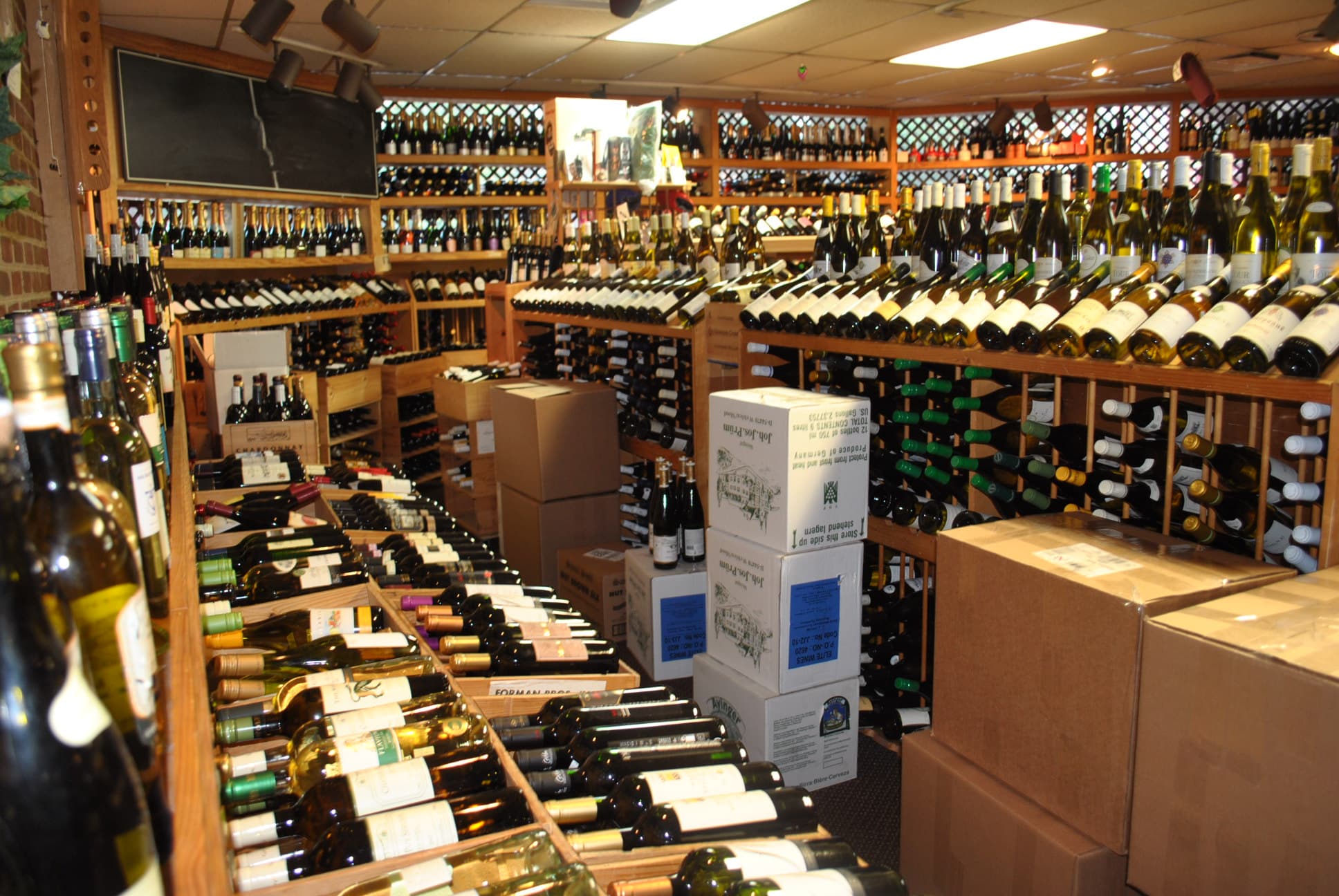 The Tastings retail floor: lattice-top wine racks wall to wall